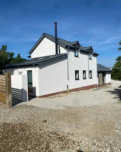 Detached home finished in white render by PureRend